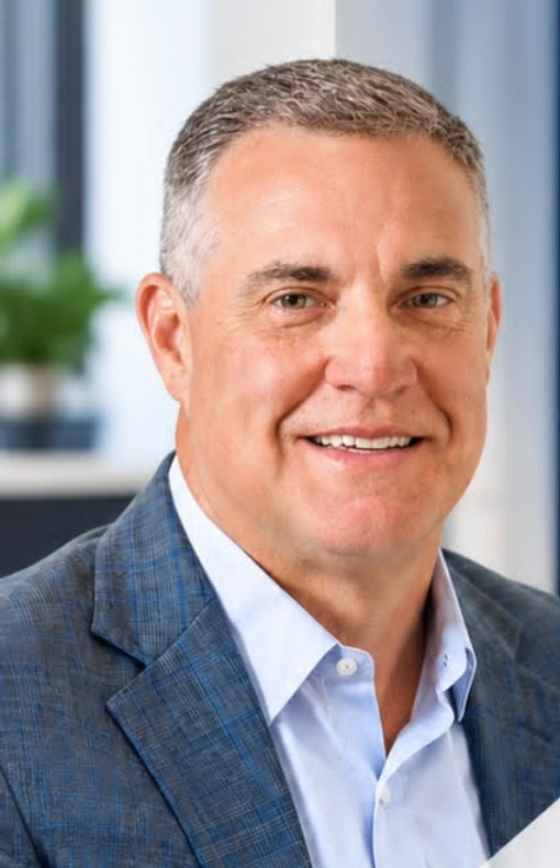 Professional man in a blue checked blazer, pictured in the supplied recruitment graphic